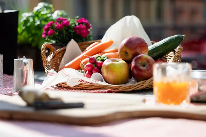 Freshly prepared brunch with local products served on the terrace overlooking the vibrant town of Brig.