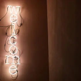 Eingangsbereich Welcome Leuchtschrift im Hotel de Londres in Brig